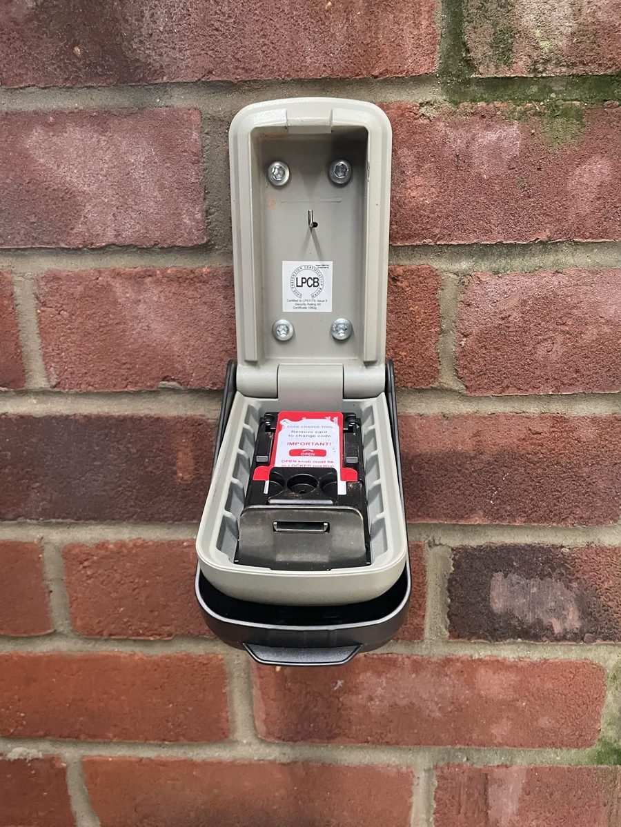 Police-approved key safe open showing a spare house key inside