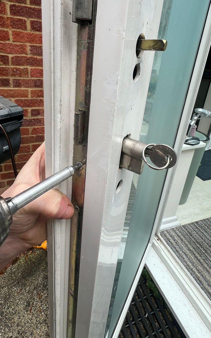 Taking the euro cylinder out of the door edge, key still in the lock