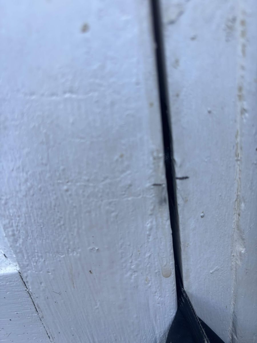 Pencil marks on a door frame showing where the lock bolt meets the keep
