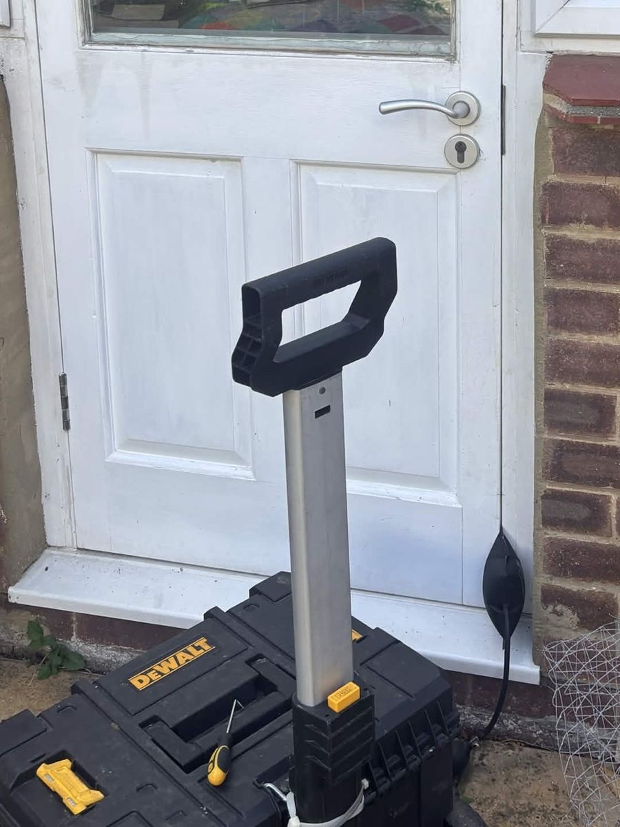 Timber garden door held with inflatable air wedges while the mortise lock is adjusted