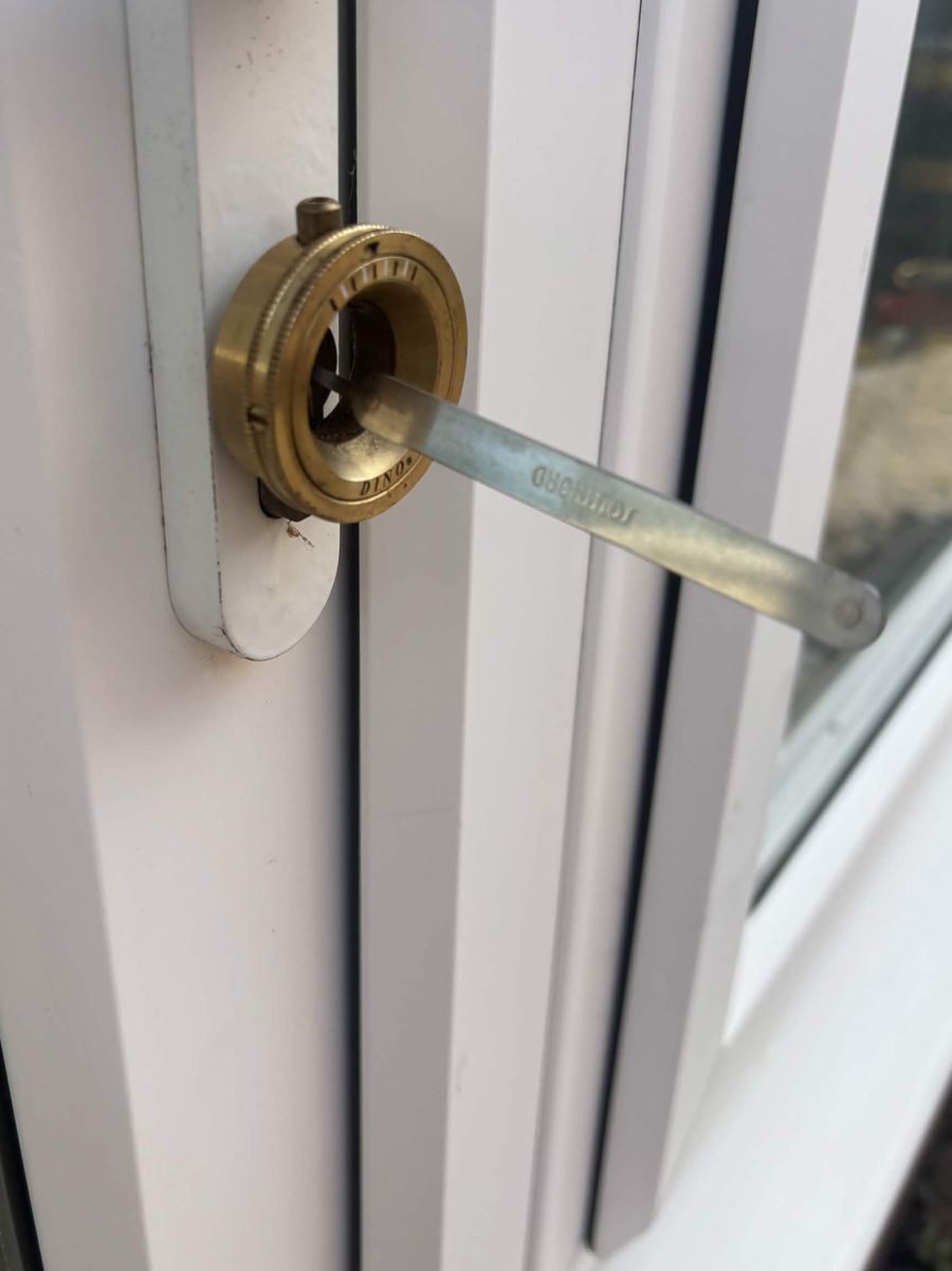 Locksmith picking a uPVC side door lock open in Blackfield with a tension tool and pick, no damage to the door