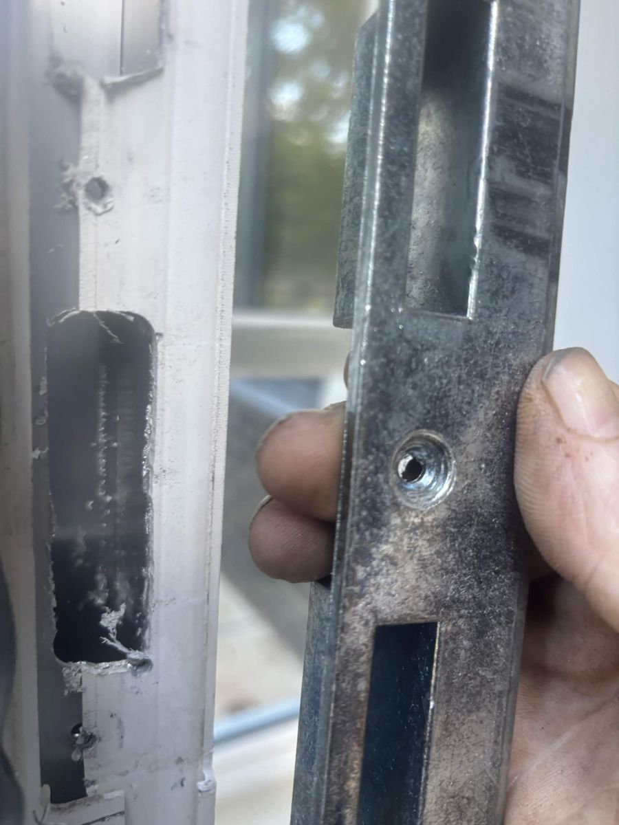 Steel keep held next to the cut-out in the door frame it came from