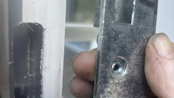 Steel keep from a composite door held beside the frame cut-out, Chandler's Ford